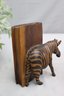 Pair Of Wooden Zebra Leaning On Book Bookends