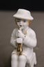 Group Lot Of Small Ceramic Figurines -flute Playing Lady, Horn Playing Kid And 1 Adventurous Boy
