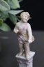 Three Hand Painted Porcelain Figurines On Floral Plinth Pedestals - Young Bacchus And Friends