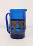 Artisan Blown Blue Glass Pitcher With Form Forcing Pierced Metal Band