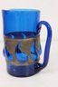 Artisan Blown Blue Glass Pitcher With Form Forcing Pierced Metal Band