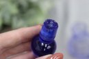 Clear Glass Perfume Bottle With Blue Swirled Line And Blue Stopper