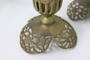 A Pair Of Ornate Brass Pierced Filigree Candle Holders