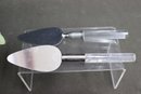 Group Lot Of Lucite And Stainless Servers - Cheese Knife Set (2), 2 Cake Servers, Butter Knife And Cap Pull