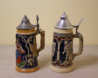 Two Vintage German Ceramic Beer Steins With Thumb Lever Cast Metal Lids
