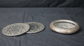 Two Round Silver-plate Trivets And Wine Coaster