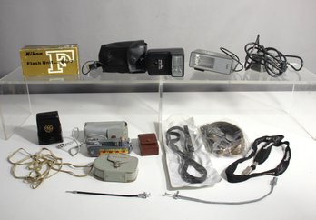 Assorted Vintage Photography Gear With Flash Units, Cables, And Accessories