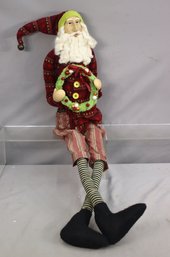 Sitting Santa Claus With Bendable Legs And Holding Wreath