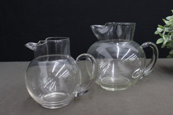 2 Glass Pitchers - A Medium And A Large Round Belly Pitcher With Handle Spout Ice Lip