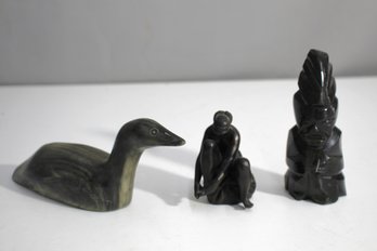 Set Of Three Sculptures: Aztec-Inspired Stone Statue, Wooden Duck, And Seated Female Nude Figurine