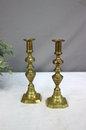 A Pair Of Brass Baluster Candlesticks