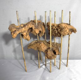 Abstract Wooden Sculpture On Bamboo Stakes - A Unique Artistic Display