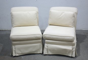 A Pair Of Skirted Rolled Back Slipper Chairs