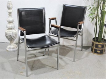 Two Classic Chrome Frame And Black Vinyl Stacking Chairs Concord Ltd.