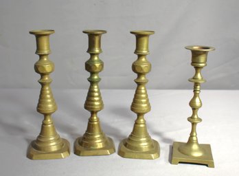 Set Of Four Vintage Brass Candlesticks With Elegant Design