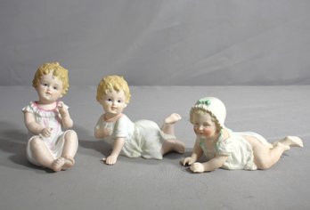 Cherubic Trio: A Collection Of Vintage Porcelain Baby Figurines