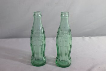 Two Empty Green Glass Coca-Cola Bottles