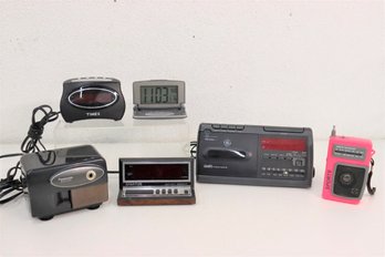 Group Lot Of Small And Portable Electronics - Clocks, Pencil Sharpener, AM/FM Sports Radio