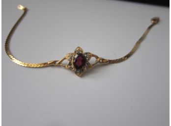 Gold Tone Bracelet With Ruby Style Stone