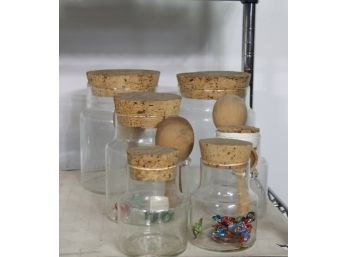 Containers With A Cork Top And Wooden Spoons