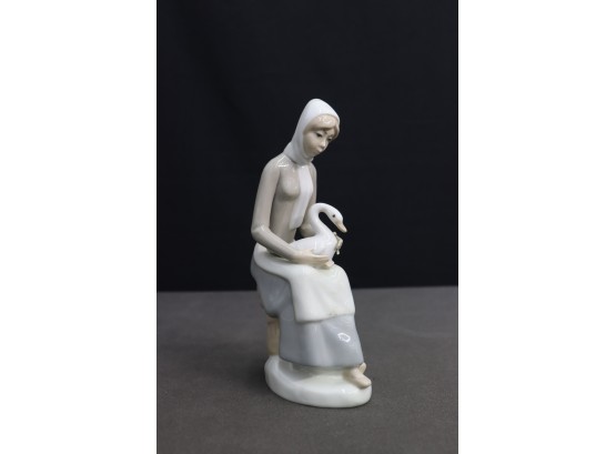 Casades Porcelanas Figurine Of A Seated Lass With Goose On Lap (Blue Logo Stamp On Bottom)
