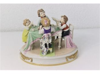 Charming Porcelain Figural Group Of Feasting Children At Table