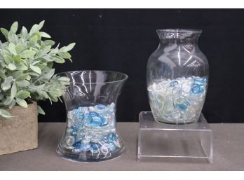 Assembly Of Clear And Light Blue Glass Flat Spheres In Two Glass Vases