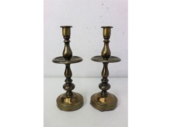 A Pair Of Tall Brass Candlesticks
