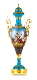 Unique Teal Porcelain And Bronze Jar Set With Cherub Details: Ornate Design And Natural Backdrop