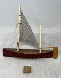 Wooden Sailboat With Striped Sail