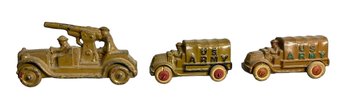 Three 1930s Toy Iron Army Trucks And A Mounted Gun Vehicle