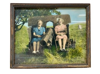 Colorized Antique Photo Of Two Elder Ladies Sitting On A Cannon