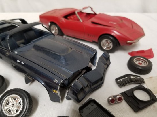 Two Vintage Car Models Needing Repair