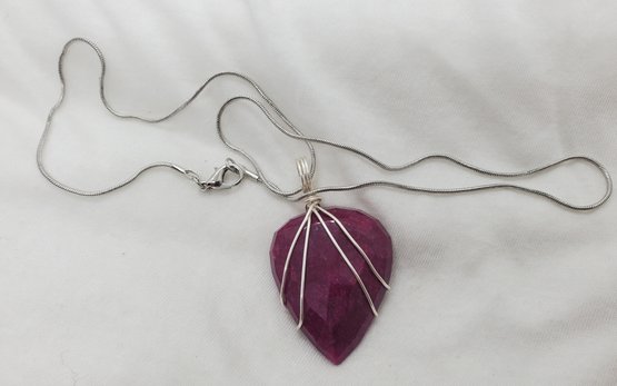 Enormous 84.50 Carat Red Ruby With Heavy Inclusions And An 18' Silver Plated Necklace