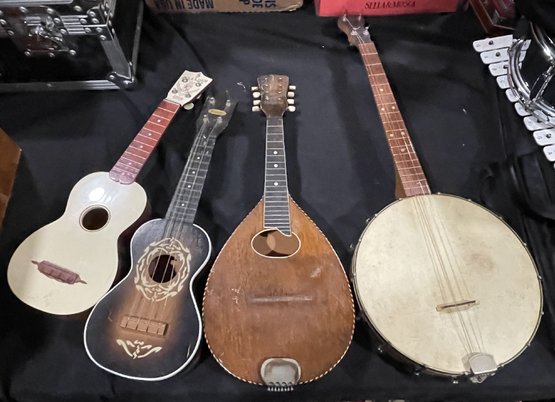 A WURLITZER BANJO AND THREE OTHER INSTRUMENTS