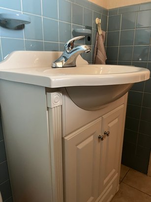 A Wood Vanity With 1 Piece Corian Type Sink - Powder Room