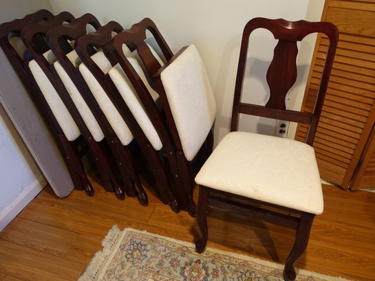 A Set Of Six Folding Wooden Chairs