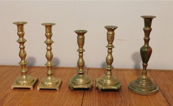 A Grouping Of Brass Candlesticks