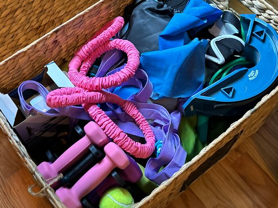 A Basket Of Workout Bands, Weights, And More