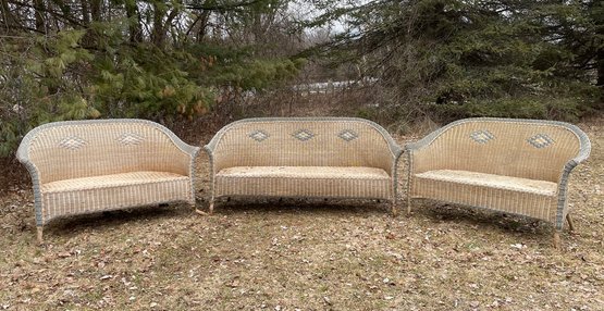 A Wicker Sofa And Two Loveseats