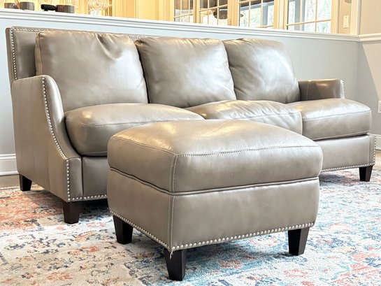 A Custom Leather Sofa With Nailhead Trim And Matching Ottoman By Bradington-Young