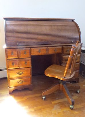 A Roll Top Desk With Chair