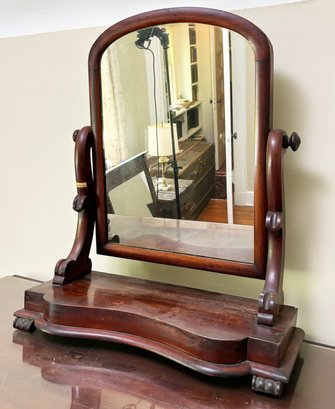 An Antique Carved Mahogany Shaving, Or Vanity Mirror