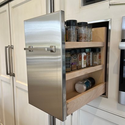 A Stainless Steel Clad Slide Out Spice Cabinet
