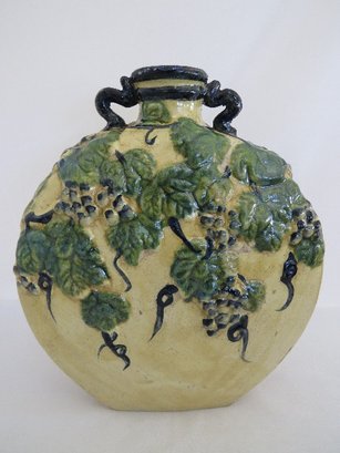 A Stoneware  Vessel With Raised Grape Vine Design
