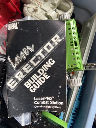 A Box Of Toys With Erector Building Guide