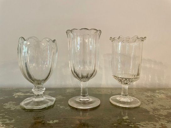 Set Of Three Footed Clear Glass Vessels By Two's Company