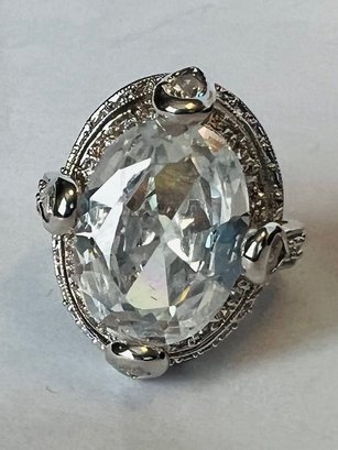 PRETTY SILVER TONE LARGE OVAL WHITE STONE CENTER WITH SURROUNDING SMALL WHITE STONES RING