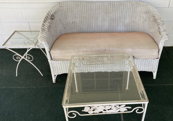 An Antique Wicker Loveseat With Two Metal And Glass Side Tables.