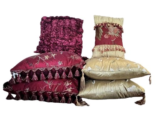 A Group Of Eight Red And Gold Decorective Pillows